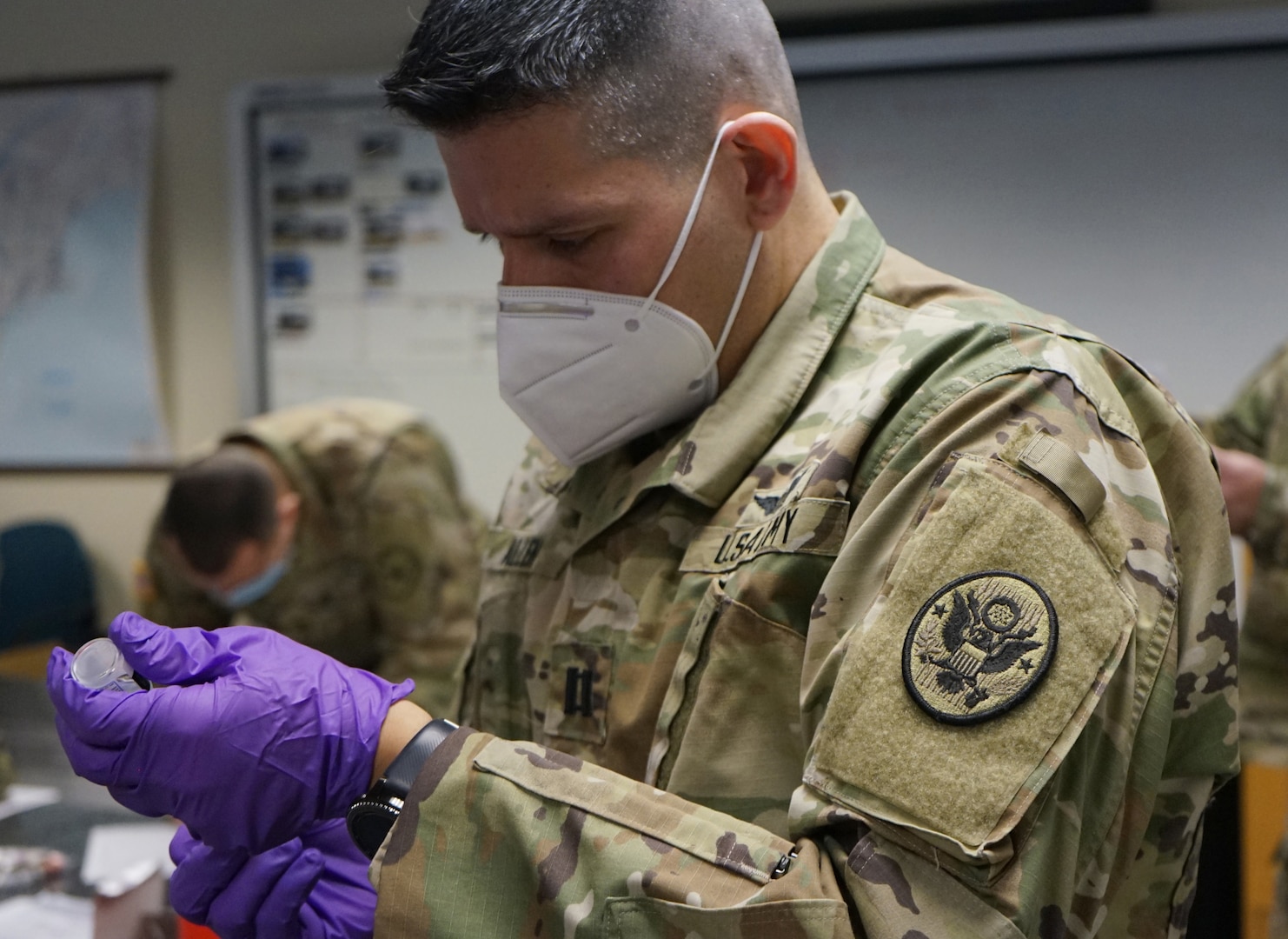 Capt. Cesar Allen, medical officer with the 3rd Civil Support Team (Weapons of Mass Destruction), Pennsylvania National Guard, prepares a dose of the Moderna COVID-19 vaccine on Jan. 13, 2021, at Fort Indiantown Gap, Pa.