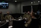 Group of Space Force personnel sitting at conference table during a briefing.