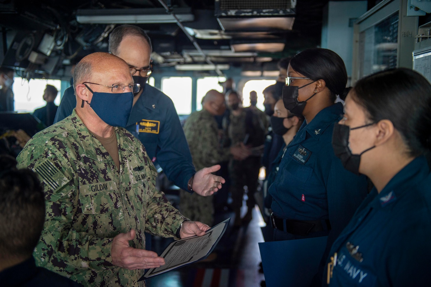 Chief of Naval Operations Adm. Mike Gilday greets Gas Turbine System Technician 3rd Class Maritza Dominguez in the pilot house aboard the guided-missile destroyer USS John Paul Jones (DDG 53).