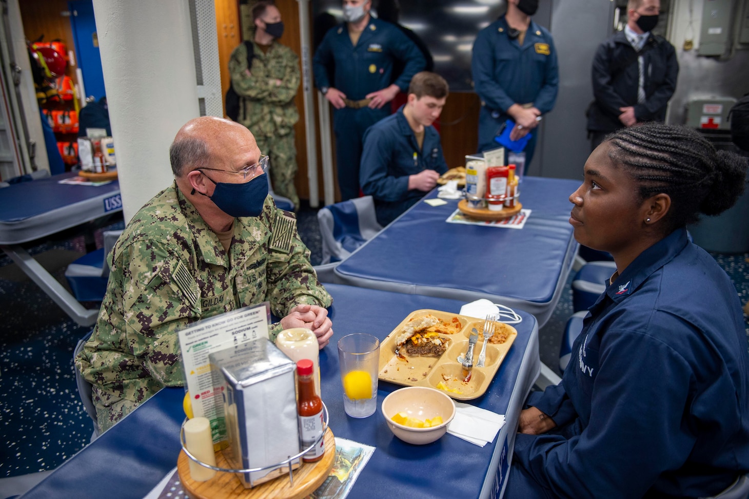 Chief of Naval Operations Adm. Mike Gilday, left, speaks with Boatswain's Mate 3rd Class Odera Weaks aboard the guided-missile destroyer USS John Paul Jones (DDG 53).
