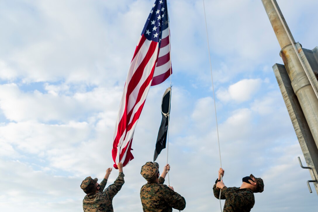Marines raise the American flag.