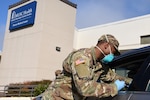 Army Spc. Matthew Jackson, South Carolina National Guard medic, vaccinates civilians during a drive-up service at the Chester Medical Center in Chester, South Carolina, Jan. 13, 2021. Guard Soldiers and Airmen have supported South Carolina hospitals and other state partners since March.