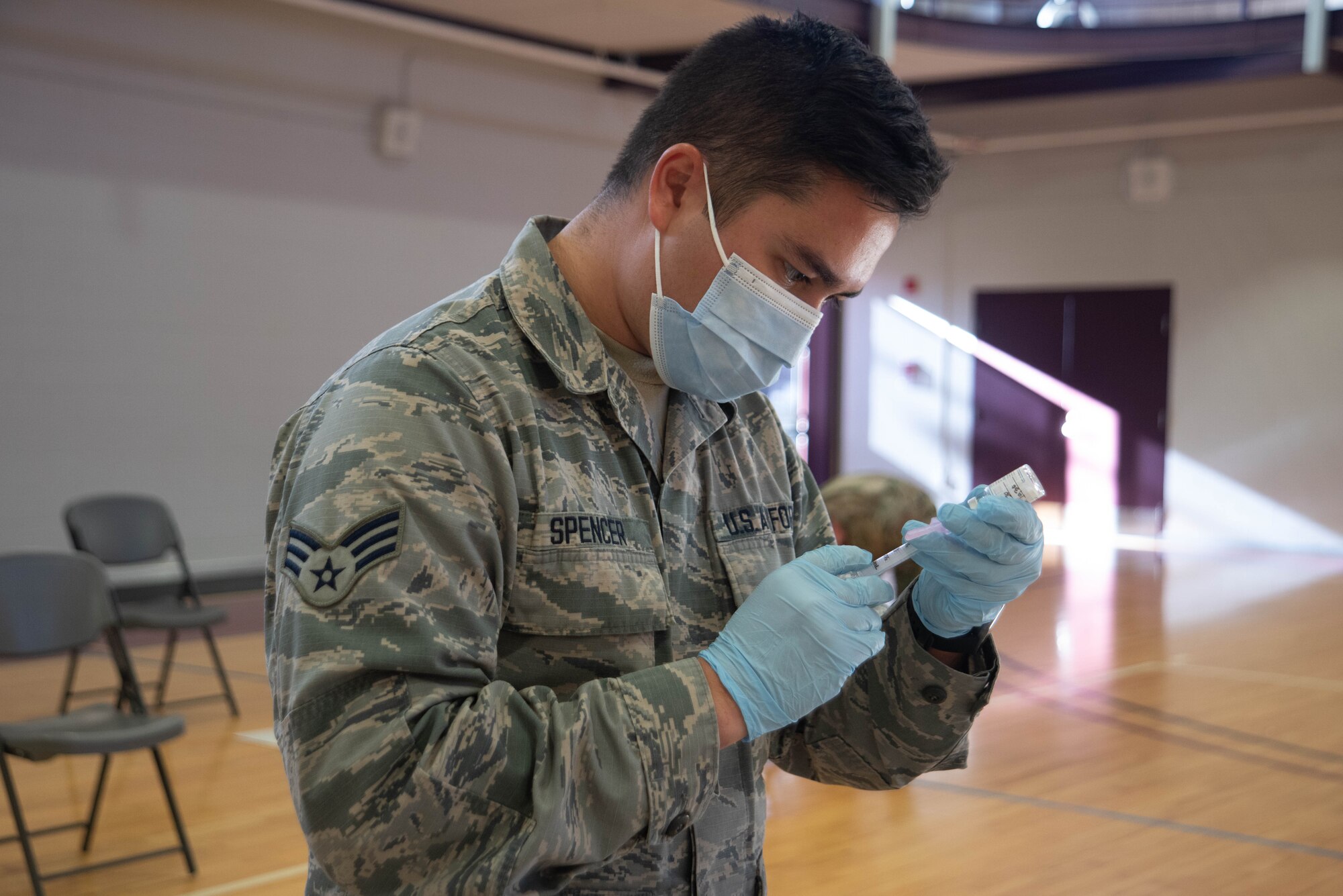 Medic fills a syringe with the Moderna COVID-19 vaccine.