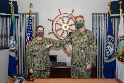 Captain Dianna Wolfson, the new Norfolk Naval Shipyard (NNSY) Commander, is congratulated by outgoing Shipyard Commander Rear Admiral Howard Markle during the Assumption of Command ceremony Jan. 15.