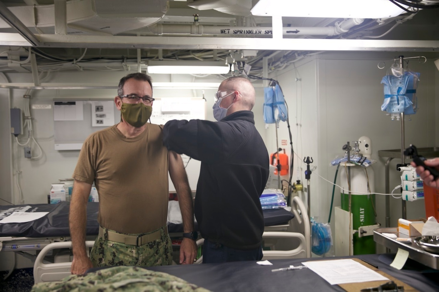 Rear Adm. Robert Katz, commander, Expeditionary Strike Group (ESG 2), receives the COVID-19 vaccination aboard the amphibious transport dock ship USS San Antonio (LPD 17), Jan. 11, 2021