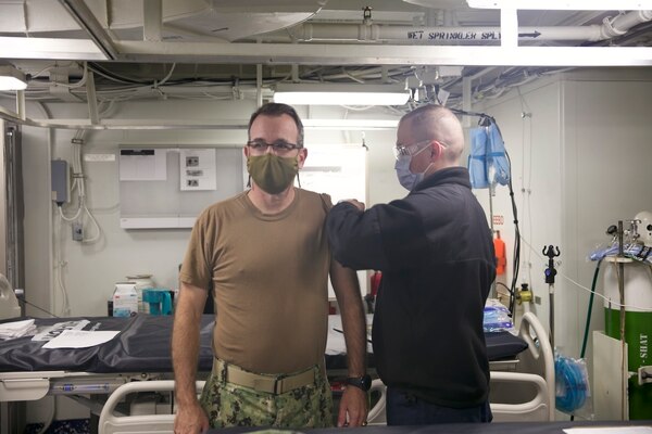 Rear Adm. Robert Katz, commander, Expeditionary Strike Group (ESG 2), receives the COVID-19 vaccination aboard the amphibious transport dock ship USS San Antonio (LPD 17), Jan. 11, 2021.