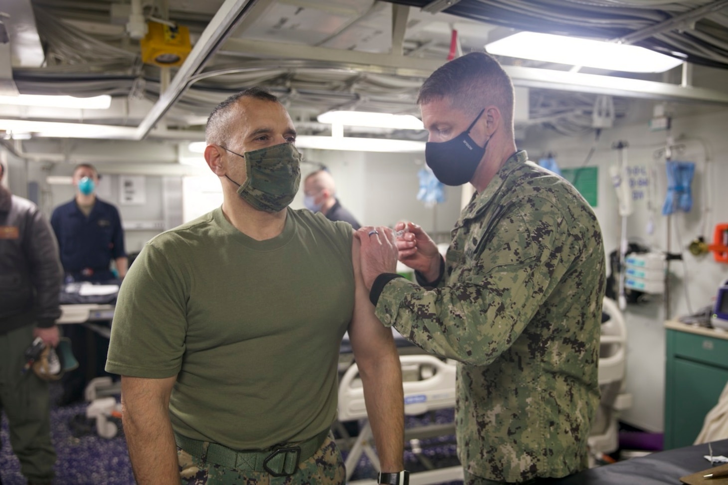 Col. Brian Duplessis, deputy commander, Expeditionary Strike Group (ESG) 2, receives the COVID-19 vaccination aboard the amphibious transport dock ship USS San Antonio (LPD 17), Jan. 11, 2021.