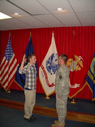 Jonathon Sweet, left,  takes the oath of enlistment into the United States Marine Corps in 2011. Now a staff sergeant in the Marine Corps, Sweet has returned to Recruiting Substation Northern Michigan to help the next generation of young men and women explore their opportunities.