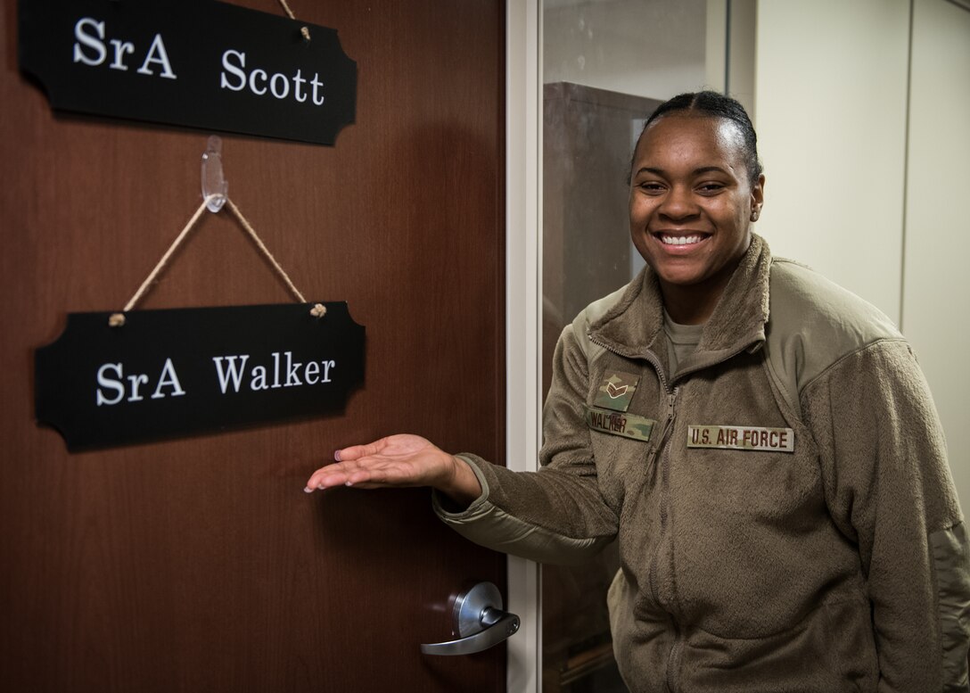 Senior Airman Jaisha Walker, 932nd Force Support Squadron career development assistant, shows off her custom made name door sign as she poses for a photo, January 14, 2021, Scott Air Force Base, Illinois. (U.S. Air Force photo by Christopher Parr)
