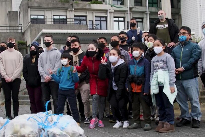 A large group of people pose for the camera.