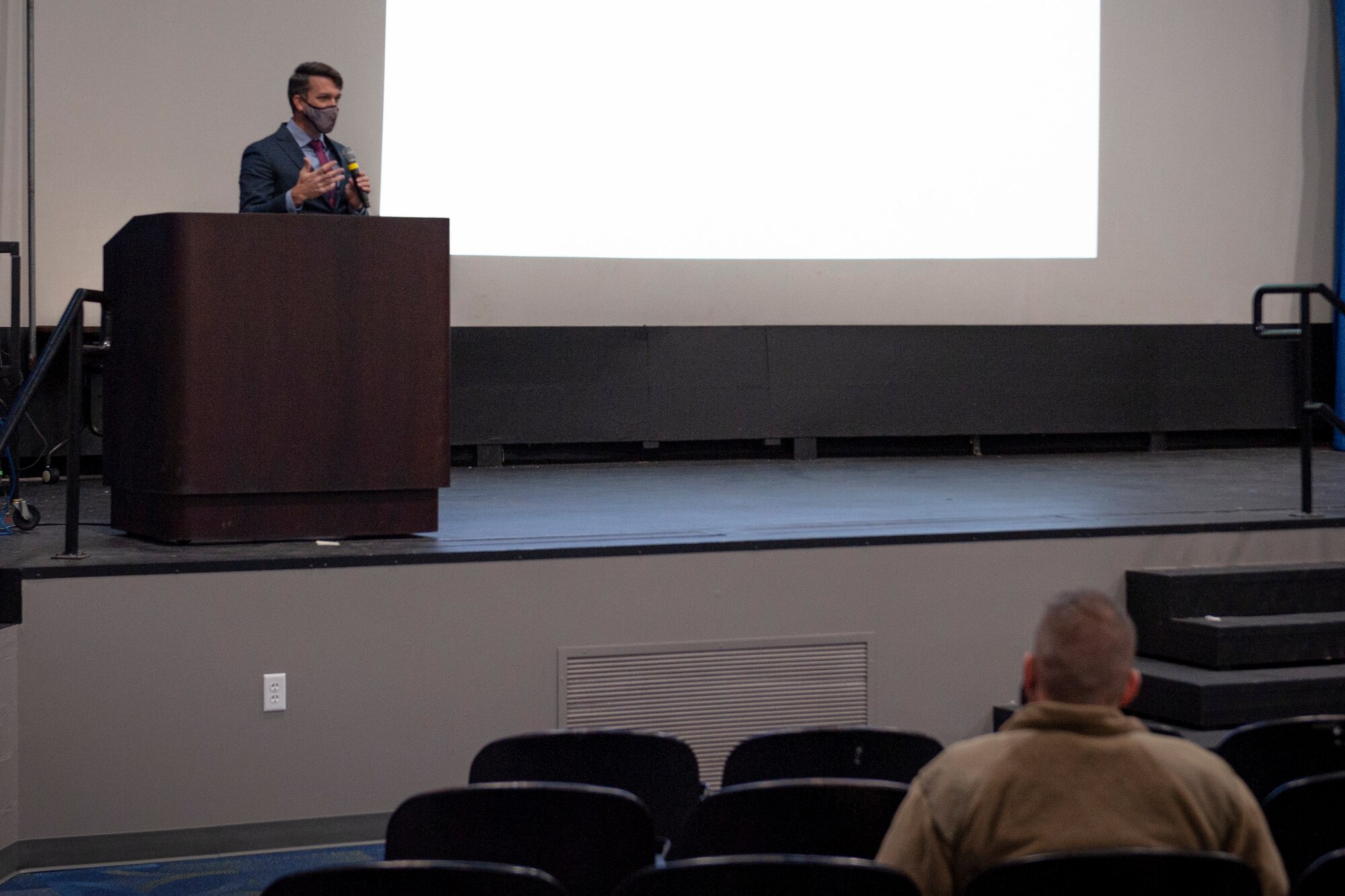 Photo of an Airman speaking during a briefing