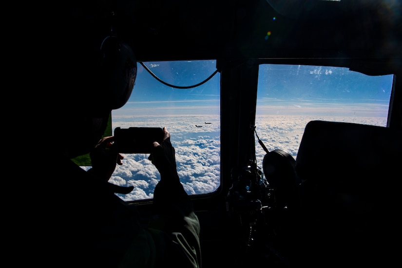 A civic leader takes photos of the the KC-46 Pegasus refueling the legacy C-17 Globemaster III over the Atlantic Ocean to showcase the present and future of the Air Force, Jan. 15, 2021.
