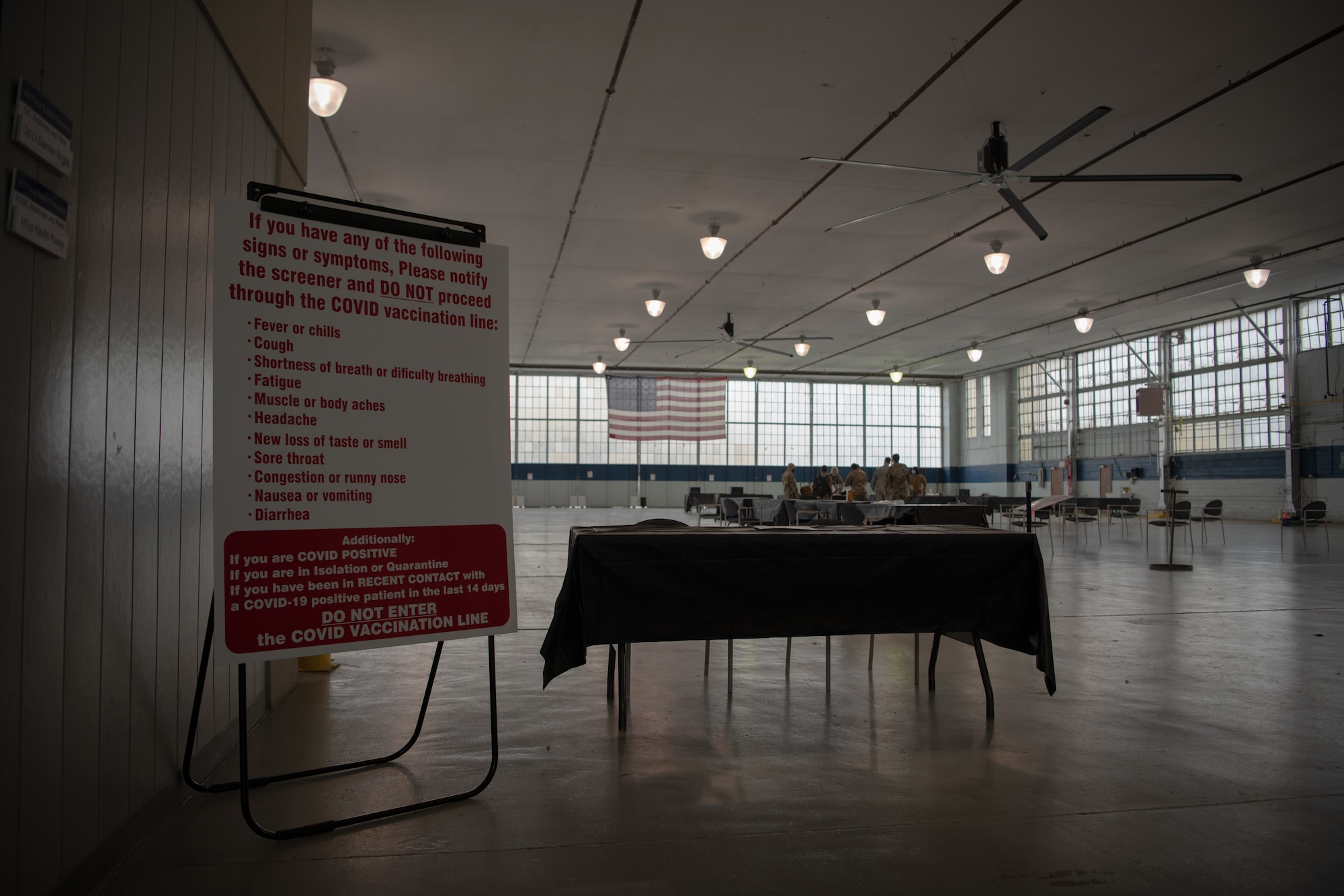A screening desk was set up in the honor guard hangar January 11, 2020, on Maxwell Air Force Base, Alabama. Airmen with the 42nd Medical Group converted the hangar into an off-site clinic, where they will begin administering the COVID-19 vaccine on January 16.