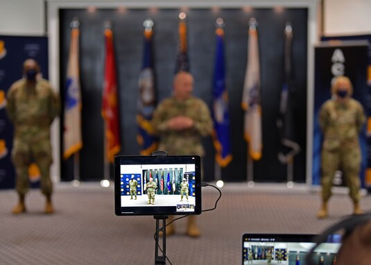 Goodfellow Air Force Base leadership appear on a zoom call during the first commander’s all call of 2021, at the Event Center on Goodfellow Air Force Base, Texas, Jan 15, 2021. The audience attended both in person and virtually to adhere to Centers for Disease Control and Prevention guidelines. (U.S. Air Force photo by Airman 1st Class Ethan Sherwood)