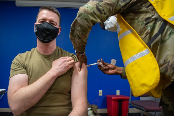 The installation commander receives the COVID-19 vaccine.