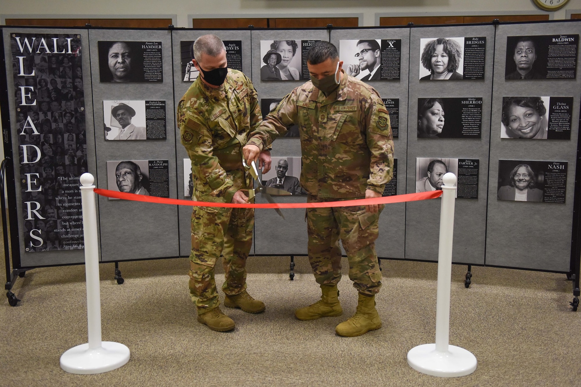 Col. Brian Collins, 62nd Airlift Wing (AW) vice commander (left), and Chief Master Sgt. Joseph Arce, 62nd AW command chief, cut a ribbon during the grand opening ceremony for the Martin Luther King Jr. and Civil Rights Movement Pop-Up Museum at Joint Base Lewis-McChord, Wash., Jan. 12, 2021. The museum will be open until Jan. 22, 2021, in honor of MLK Day. (U.S. Air Force photo by Airman 1st Class Callie Norton)