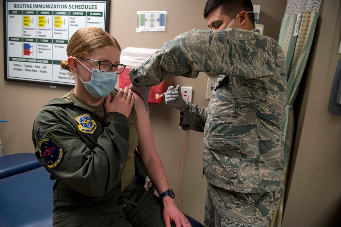 U.S. Air Force Capt. Courtney Beaver, 97th Air Refueling Squadron flight surgeon, receives Fairchild’s first Pfizer-BioNTech COVID-19 vaccine from Senior Airman Kyle Quinn, 92nd Health Care Operations Squadron immunization technician at Fairchild Air Force Base, Washington, Jan. 15, 2021. Fairchild’s 92nd Medical Group will administer the vaccine in accordance with the Department of Defense’s phased approach, which prioritizes first responders, health care workers, public safety personnel and select deploying individuals. (U.S. Air Force photo by Senior Airman Lawrence Sena)