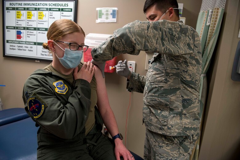 U.S. Air Force Capt. Courtney Beaver, 97th Air Refueling Squadron flight surgeon, receives Fairchild’s first Pfizer-BioNTech COVID-19 vaccine from Senior Airman Kyle Quinn, 92nd Health Care Operations Squadron immunization technician at Fairchild Air Force Base, Washington, Jan. 15, 2021. Fairchild’s 92nd Medical Group will administer the vaccine in accordance with the Department of Defense’s phased approach, which prioritizes first responders, health care workers, public safety personnel and select deploying individuals. (U.S. Air Force photo by Senior Airman Lawrence Sena)