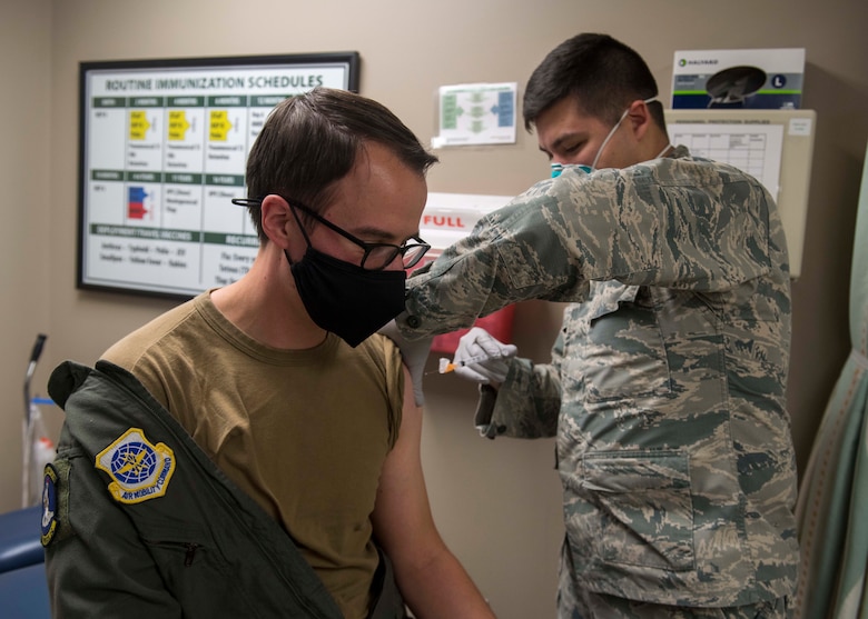 U.S. Air Force Capt. Roger Brogis, 36th Rescue Squadron flight surgeon, receives Fairchild’s second Pfizer-BioNTech COVID-19 vaccine from Senior Airman Kyle Quinn, 92nd Health Care Operations Squadron immunization technician at Fairchild Air Force Base, Washington, Jan. 15, 2021. The end-state is that the DoD is able to reduce the burden of COVID-19 in high-risk populations and simultaneously mitigate risk to military operations. (U.S. Air Force photo by Senior Airman Lawrence Sena)