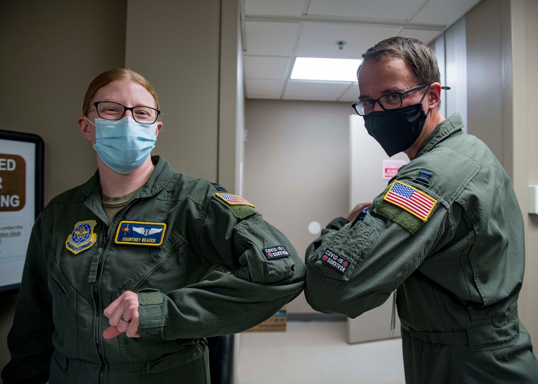 U.S. Air Force Capt. Courtney Beaver, 97th Air Refueling Squadron flight surgeon and Capt. Roger Brogis, 36th Rescue Squadron flight surgeon, celebrate receiving the first batch of the Pfizer-BioNTech COVID-19 vaccine at Fairchild Air Force Base, Washington, Jan. 15, 2021. Receiving the vaccine is voluntary, but all DoD personnel are encouraged to get it to protect their health, their families and their community. (U.S. Air Force photo by Senior Airman Lawrence Sena)