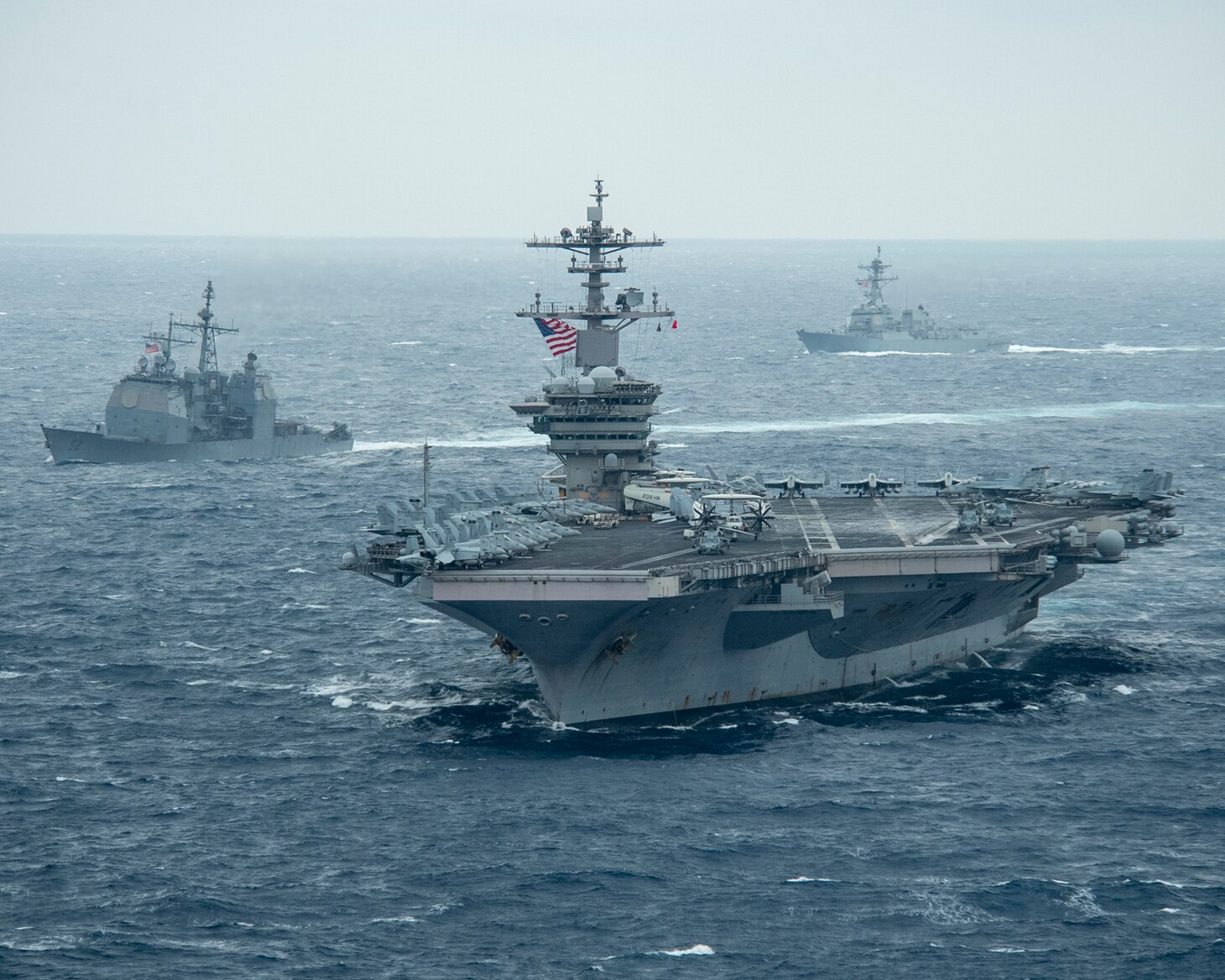 PACIFIC OCEAN (Jan. 15, 2021) – The aircraft carrier USS Theodore Roosevelt (CVN 71), front, Ticonderoga-class guided-missile cruiser USS Bunker Hill (CG 52), left, and Arleigh Burke-class guided-missile destroyer USS John Finn (DDG 113) transit the Pacific Ocean Jan. 15, 2021. The Theodore Roosevelt Carrier Strike Group is on a scheduled deployment to the U.S. 7th Fleet area of operations. As the U.S. Navy's largest forward deployed fleet, with its approximate 50-70 ships and submarines, 140 aircraft, and 20,000 Sailors in the area of operations at any given time, 7th Fleet conducts forward-deployed naval operations in support of U.S. national interests throughout a free and open Indo-Pacific area of operations to foster maritime security, promote stability, and prevent conflict alongside 35 other maritime nations and partners. (U.S. Navy photo by Mass Communication Specialist 2nd Class Casey Scoular)