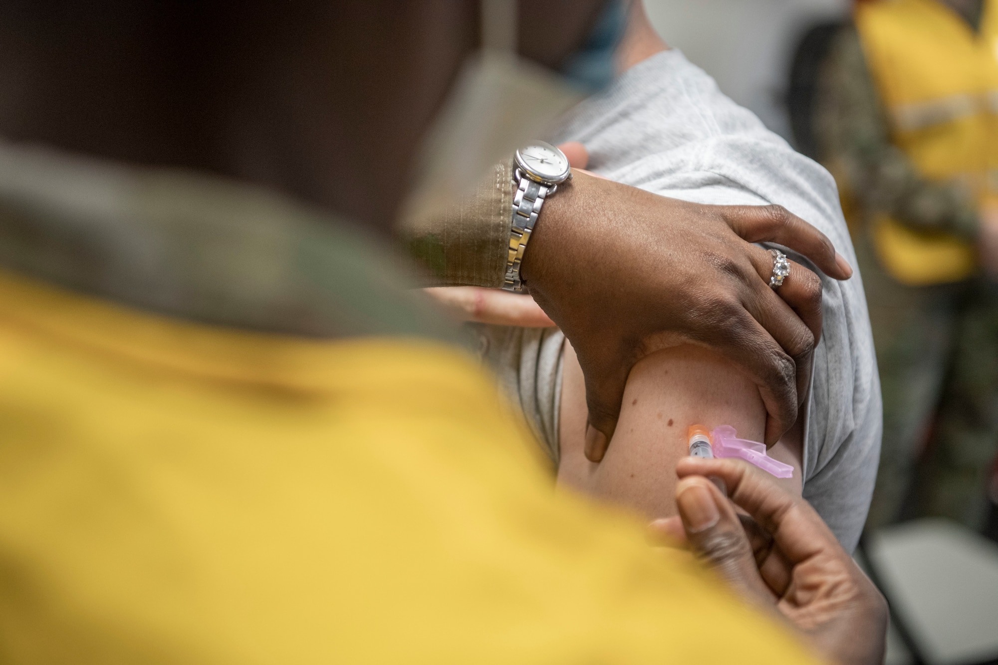 An Airman receives a COVID-19 vaccine in the left arm.