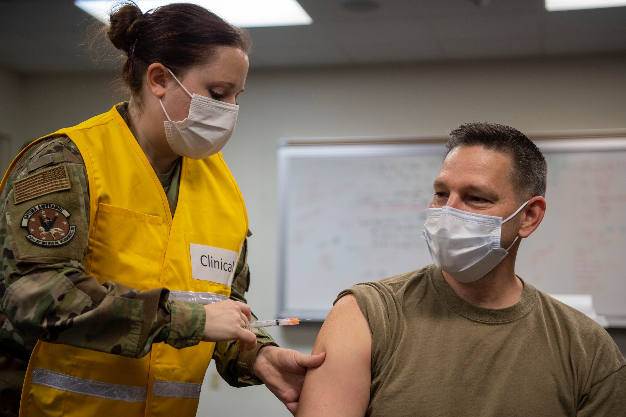 The 19th Medical Group superintendent receives the COVID-19 vaccine from a medical technician.