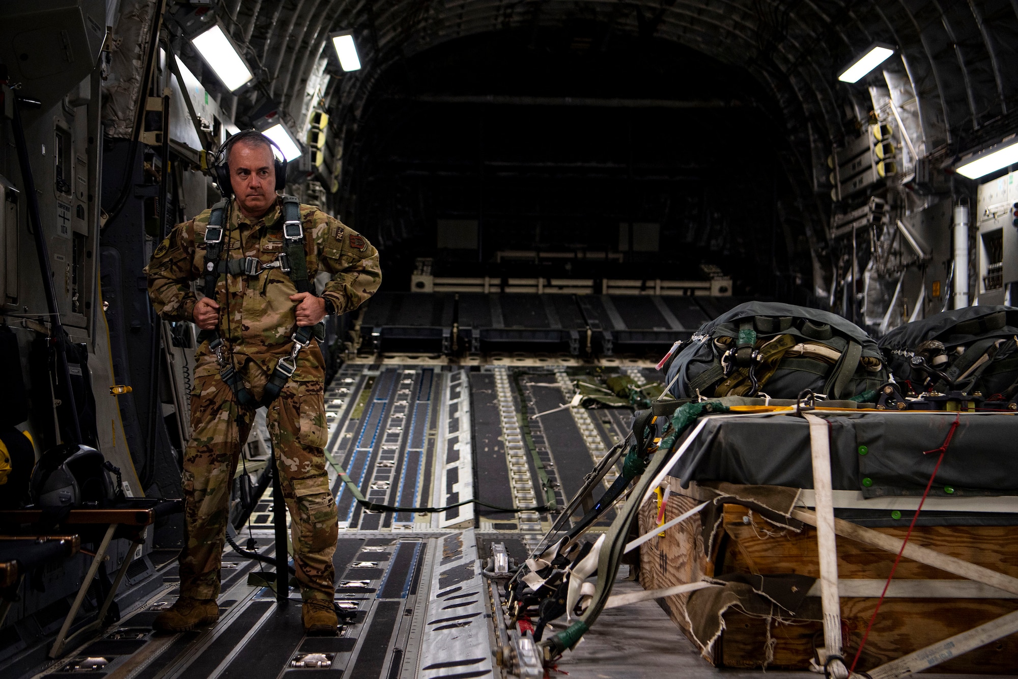 An Airman from the 791st Airlift Squadron adjusts his harness on a C-17 Globemaster III above North Field North, S.C., Jan. 15, 2021.