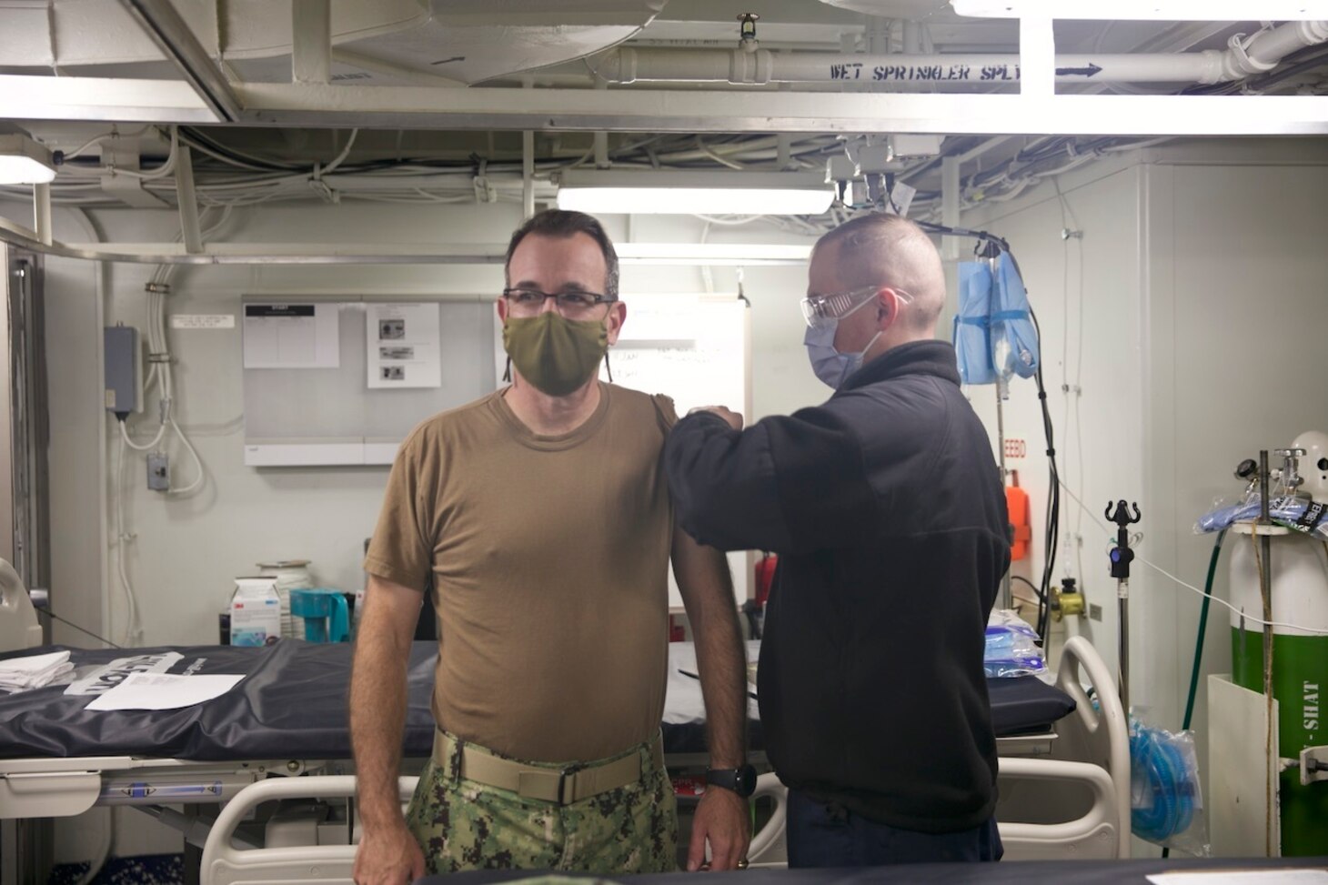 Rear Adm. Robert Katz, commander, Expeditionary Strike Group (ESG 2), receives the COVID-19 vaccination aboard the amphibious transport dock ship USS San Antonio (LPD 17), Jan. 11, 2021.
