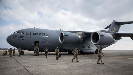 Members of the North Carolina National Guard deboard a C-17 Globemaster III, assigned to the 145th Airlift Wing, North Carolina Air National Guard, upon arrival to Joint Base Andrews, Md., Jan. 15, 2021. National Guard Soldiers and Airmen from numerous states have traveled to Washington, D.C., to support federal and district authorities leading up to the 59th presidential inauguration.
