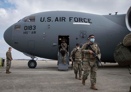 Members of the North Carolina National Guard deboard a C-17 Globemaster III, assigned to the 145th Airlift Wing, North Carolina Air National Guard, upon arrival to Joint Base Andrews, Md., outside Washington, D.C., on Jan. 15, 2021. National Guard Soldiers and Airmen are supporting federal and district authorities for the 59th presidential inauguration.