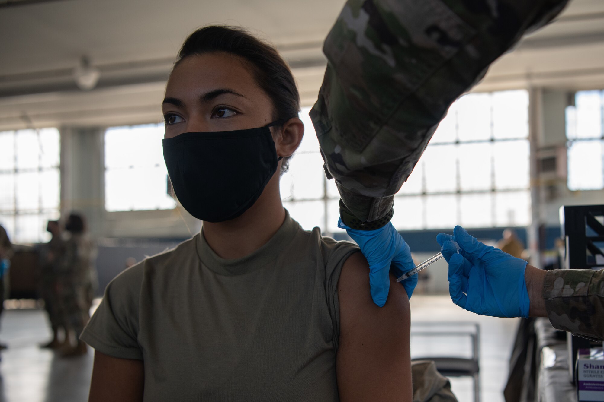 2nd Lt. Meggan Tamondong, an officer trainee at Officer Training School, receives her second dose of the COVID-19 vaccine Jan. 16, 2020, at the off-site clinic in the Honor Guard hangar on Maxwell Air Force Base, Alabama. Tamondong received her first dose of the vaccine when she was working as a nurse, before she joined the Air Force in December.