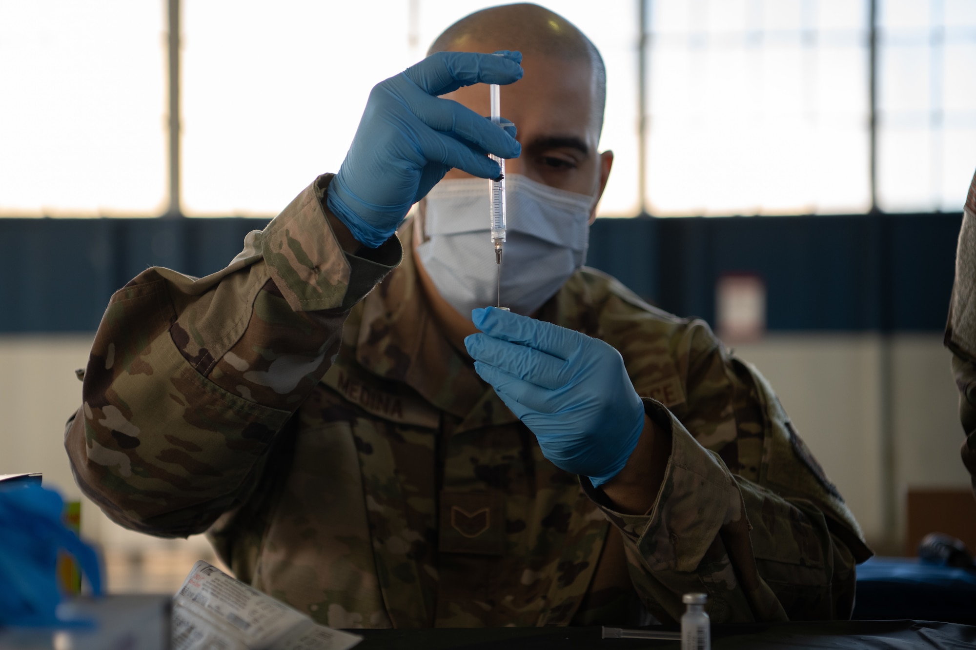 Staff Sgt. Jason Medina, 42nd Medical Group immunizations noncommissioned officer in charge, prepares the COVID-19 vaccine for administration Jan. 16, 2020, at the off-site clinic in the Honor Guard hangar on Maxwell Air Force Base, Alabama. Vaccines are currently voluntary and will be administered via appointment only, adhering to the prioritization schema developed by the Centers for Disease Control and Prevention and the Department of Defense.