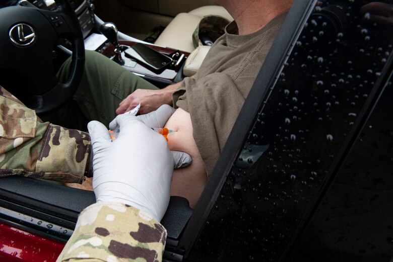 Airman administering a vaccine.