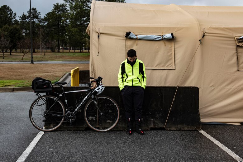 Airman waiting by a tent.