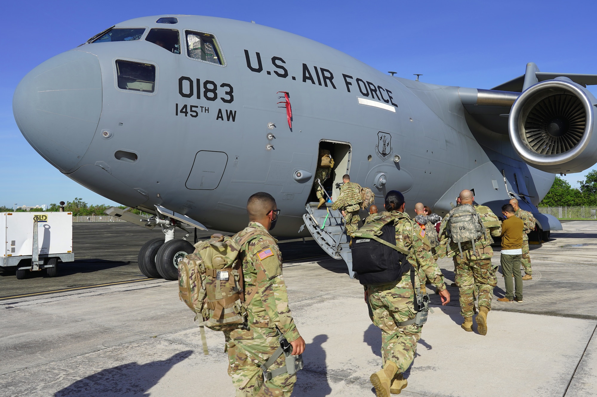 U.S. Army Soldiers with the 92nd Military Police Brigade, Puerto Rico Army National Guard, board a C-17 Globemaster III aircraft from the 145th Airlift Wing, to depart from Muñiz Air National Guard Base for Washington, D.C., in support of the 2021 presidential inauguration, Jan. 15, 2021.