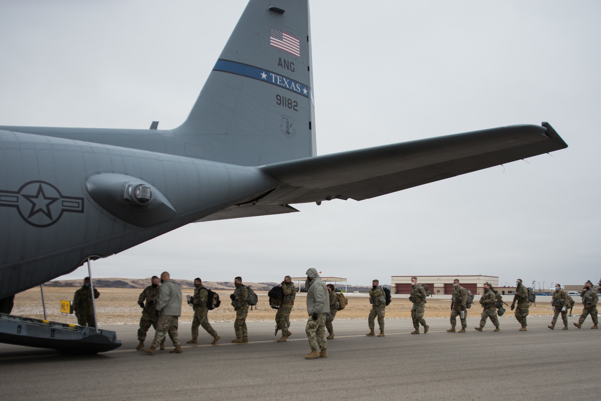 North Dakota National Guard Soldiers from the 816th Military Police Company, Bismarck N.D., file into a C-130H2 aircraft assigned to the 136th Airlift Wing out of Fort Worth, Texas, Jan. 15, 2021. The Citizen-Soldiers departed for Washington, D.C., in support of the 59th presidential inauguration.