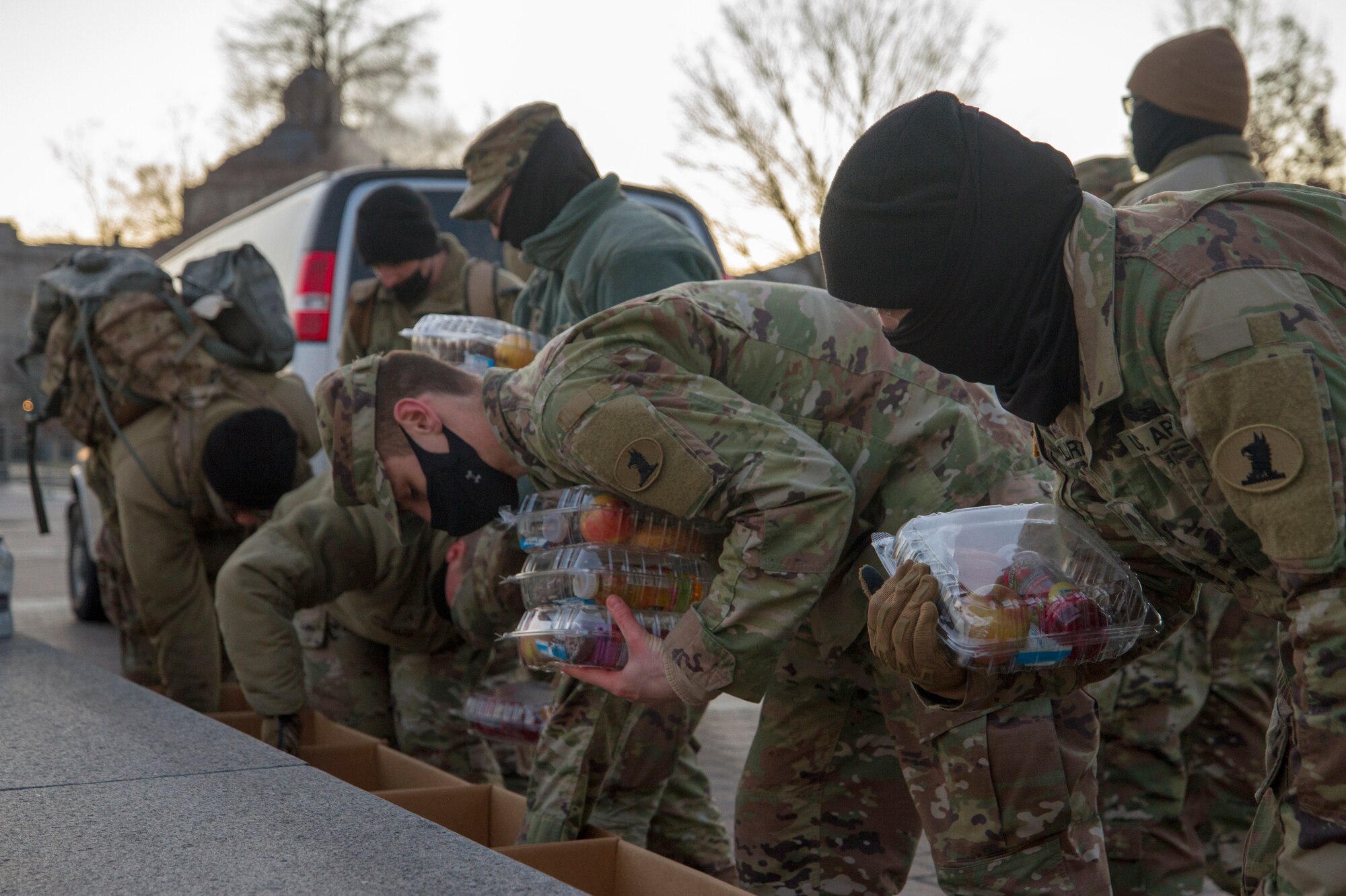 Soldiers and Airmen with the Delaware National Guard grab breakfast boxes while on duty near the U.S. Capitol, Jan. 12, 2021. National Guard officials are stressing that the Soldiers and Airmen from all 50 states, three territories and Washington, D.C., are receiving adequate food and lodging as they continue to support federal and local authorities leading up to the 59th presidential inauguration.