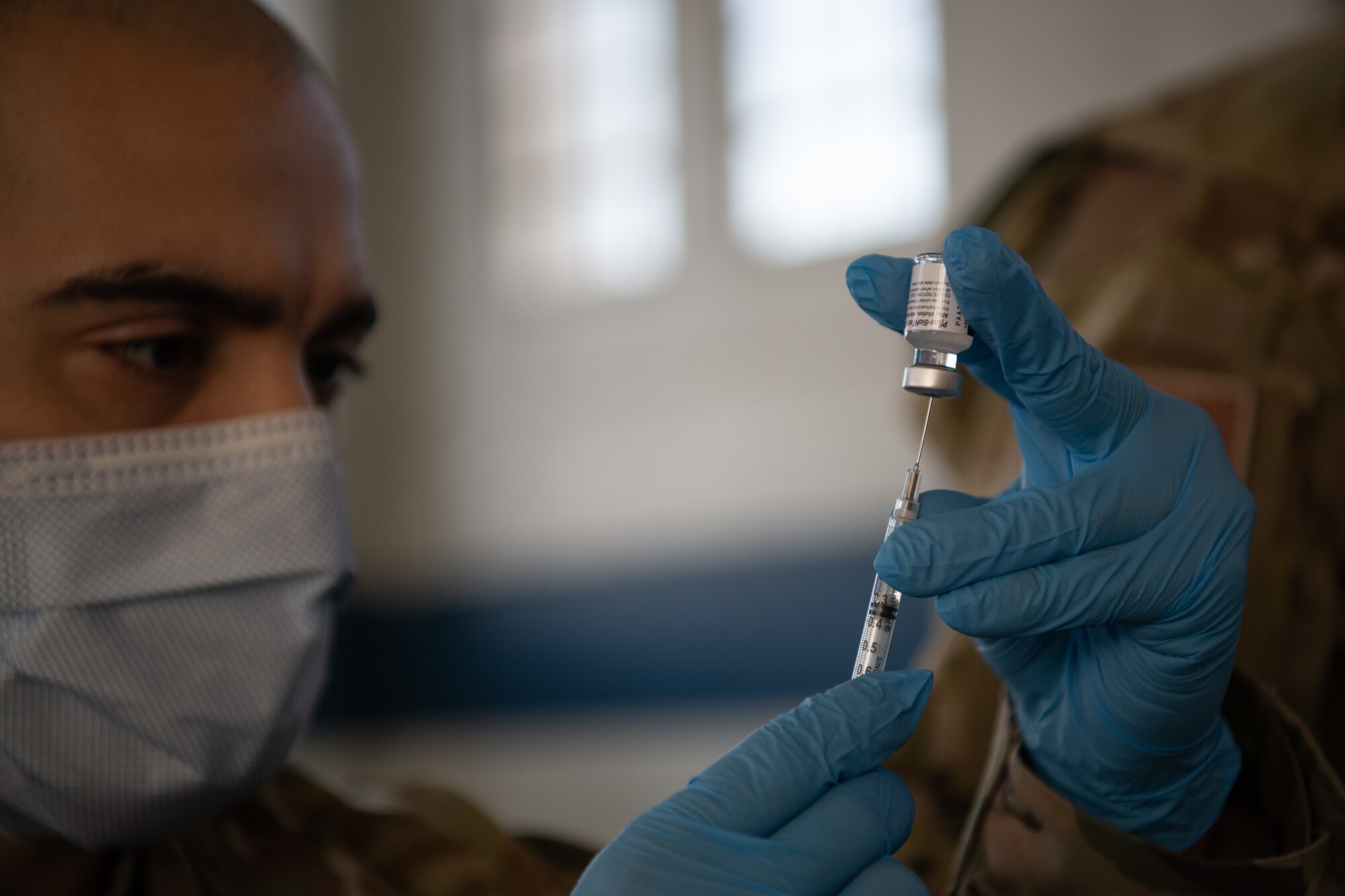 Staff Sgt. Jason Medina, 42nd Medical Group immunizations noncommissioned officer in charge, prepares the COVID-19 vaccine for administration Jan. 16, 2020, at the off-site clinic in the Honor Guard hangar on Maxwell Air Force Base, Alabama. The 42nd Medical Group aims to administer the available doses of the vaccine in a five-day time frame.