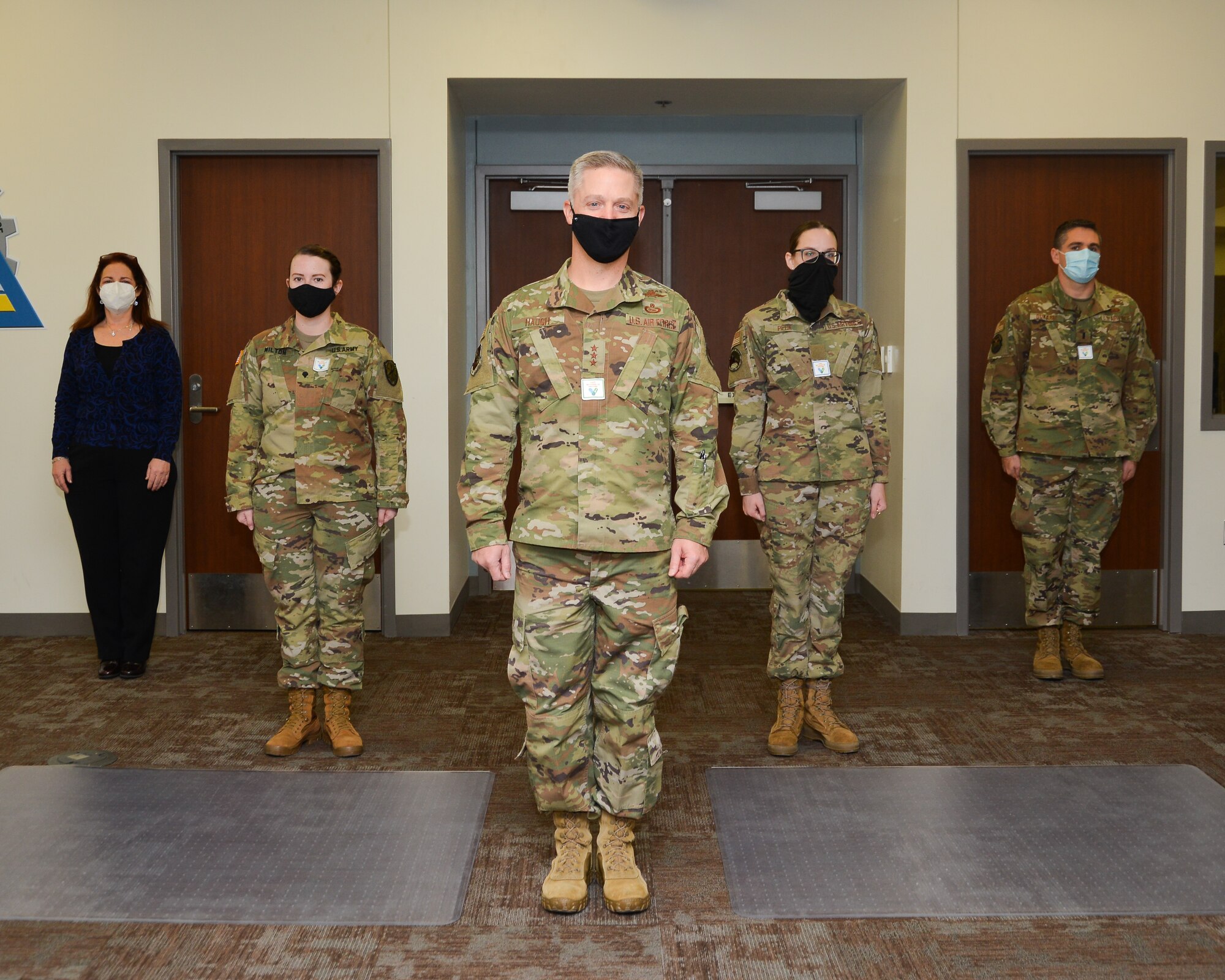 Airmen in uniform stand in a formation.
