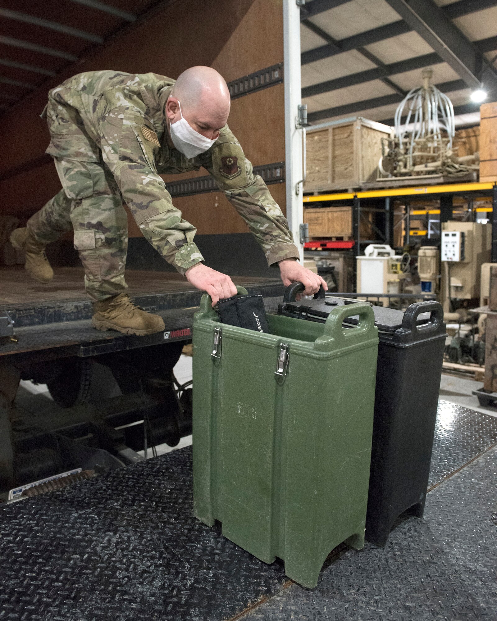 Tech. Sgt. Eric Lengle loads drink containers onto a truck while preparing to deploy in support of service members in the D.C. area for the 59th Presidential Inauguration.