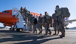 Louisiana National Guard Soldiers and Airmen from throughout the state board a plane to Washington, D.C., from Alexandria, La., on Jan. 16, 2021. They will support the District of Columbia National Guard and local and federal authorities through the presidential inauguration in the nation's capital.