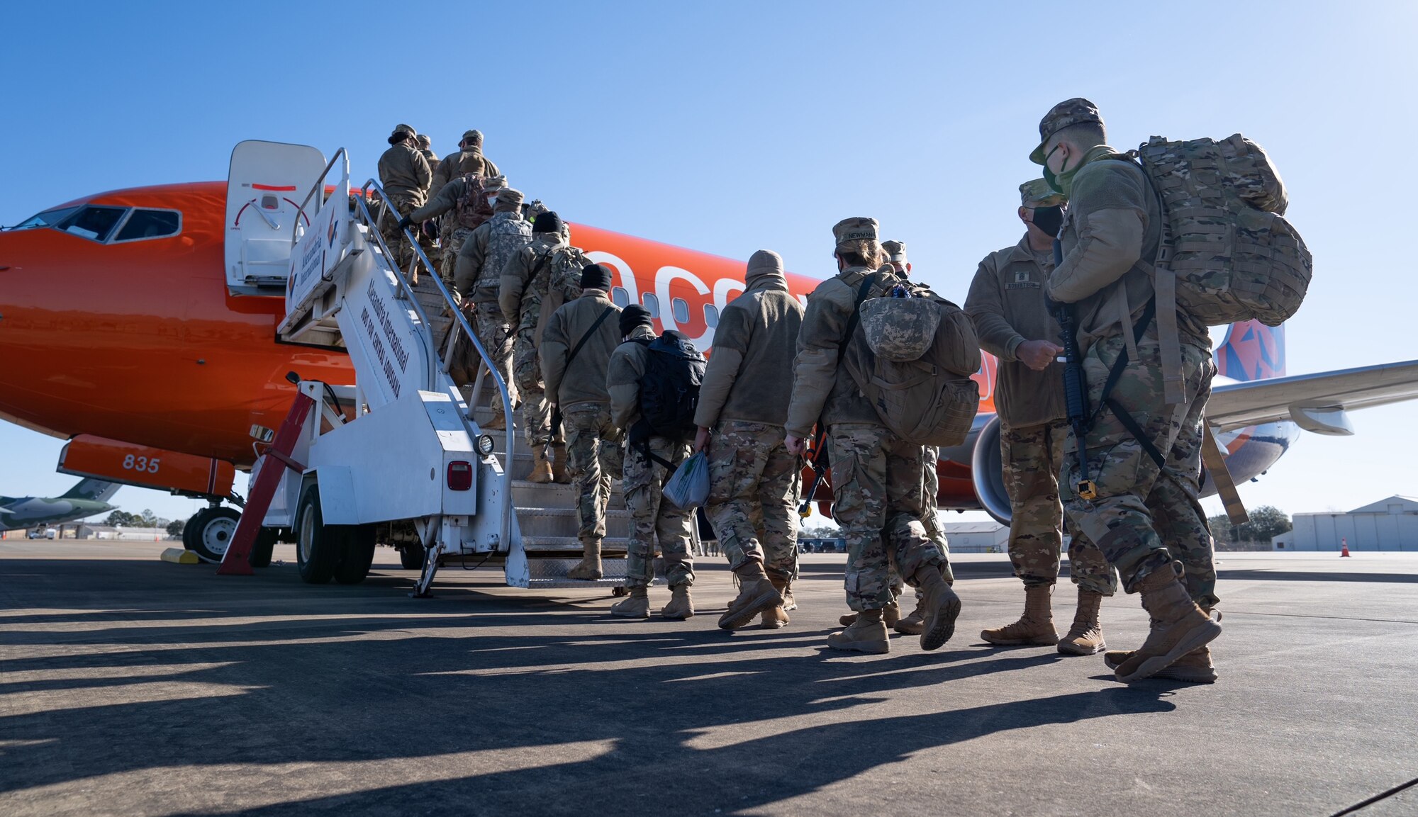 Louisiana National Guard Soldiers and Airmen from throughout the state board a plane to Washington, D.C., from Alexandria, La., on Jan. 16, 2021. They will support the District of Columbia National Guard and local and federal authorities through the presidential inauguration in the nation's capital.