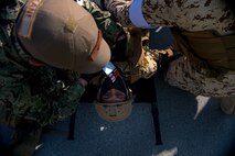 210113-N-KZ419-1348 U.S. 5TH FLEET AREA OF OPERATIONS (Jan. 13, 2021) Bahrain Defense Force and U.S. Naval Forces Central Command personnel treat a simulated medical casualty during a joint anti-terrorism and mass casualty exercise in the U.S. 5th Fleet area of operations, Jan. 13. The bilateral exercise focused on enhancing mutual security and anti-terrorism capabilities by testing responses to simulated scenarios.  (U.S. Navy photo by Mass Communication Specialist 3rd Class Dawson Roth)