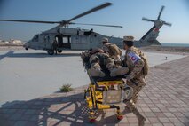 210113-N-KZ419-1438 U.S. 5TH FLEET AREA OF OPERATIONS (Jan. 13, 2021) Bahrain Defense Force personnel transport a simulated medical casualty during in a joint anti-terrorism and mass casualty exercise with U.S. Naval Forces Central Command in the U.S. 5th Fleet Area of Operations, Jan. 13. The bilateral exercise focused on enhancing mutual security and anti-terrorism capabilities by testing responses to simulated scenarios. (U.S. Navy photo by Mass Communication Specialist 3rd Class Dawson Roth)
