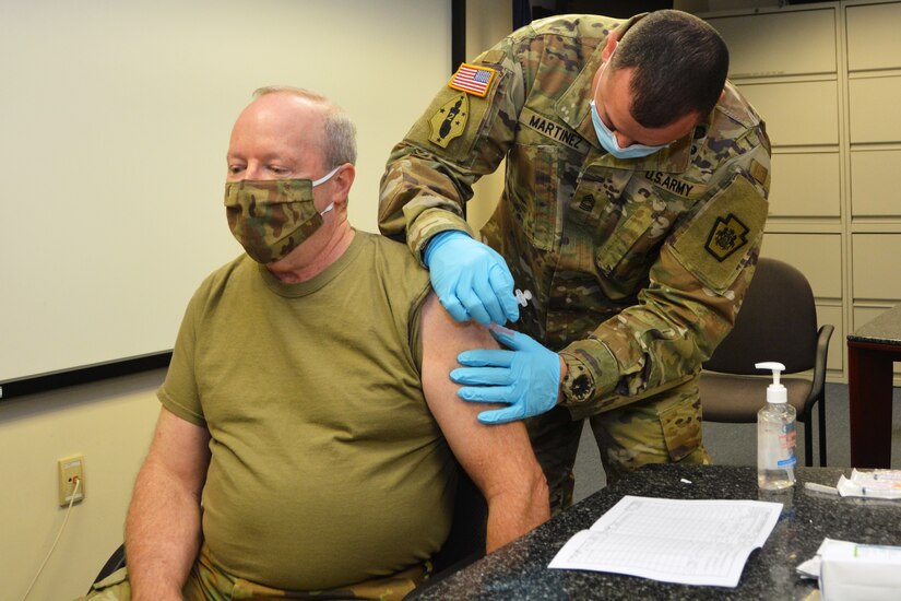Brig. Gen. Michael J. Regan Jr., deputy adjutant general - Air, Pennsylvania National Guard, receives the COVID-19 vaccine from Master Sgt. Jose Martinez, a medical operations non commissioned officer with the Pennsylvania National Guard, on Jan. 13, 2021, at Fort Indiantown Gap, Pa.