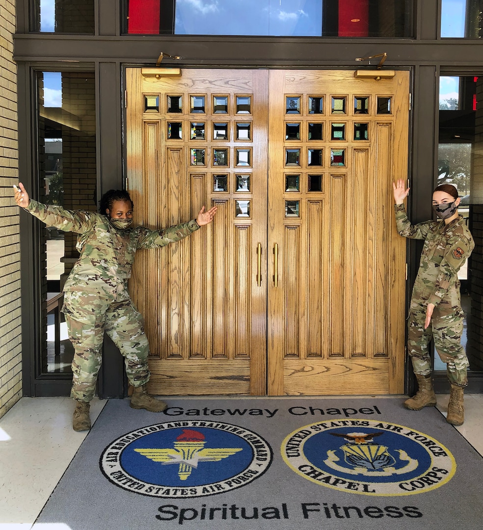 Senior Airman Tamera Fowler (left) and Senior Airman Lillian Griffith (right), Religious Affairs Airmen at Joint Base San Antonio-Lackland, stand at the main entrance to the Gateway Chapel. The Airmen will answer questions from potential Air and Space Force enlistees during an Air Force Recruiting Service social media chat session Jan. 27, 2021.