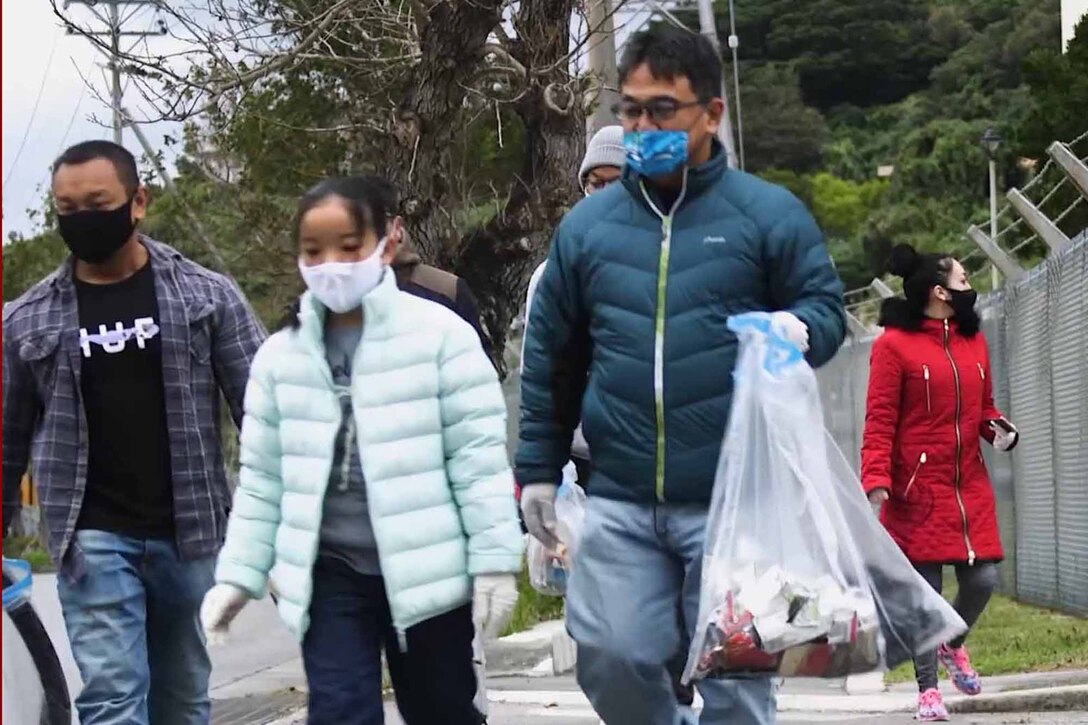 うるま市にある米海兵隊基地キャンプ・コートニーから出発した海兵隊員と地元住民が、約２キロの道のりでゴミを拾いました。