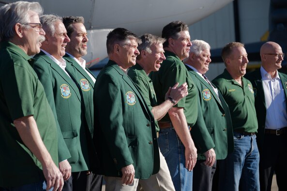 Retirees pose for photo on flight line.