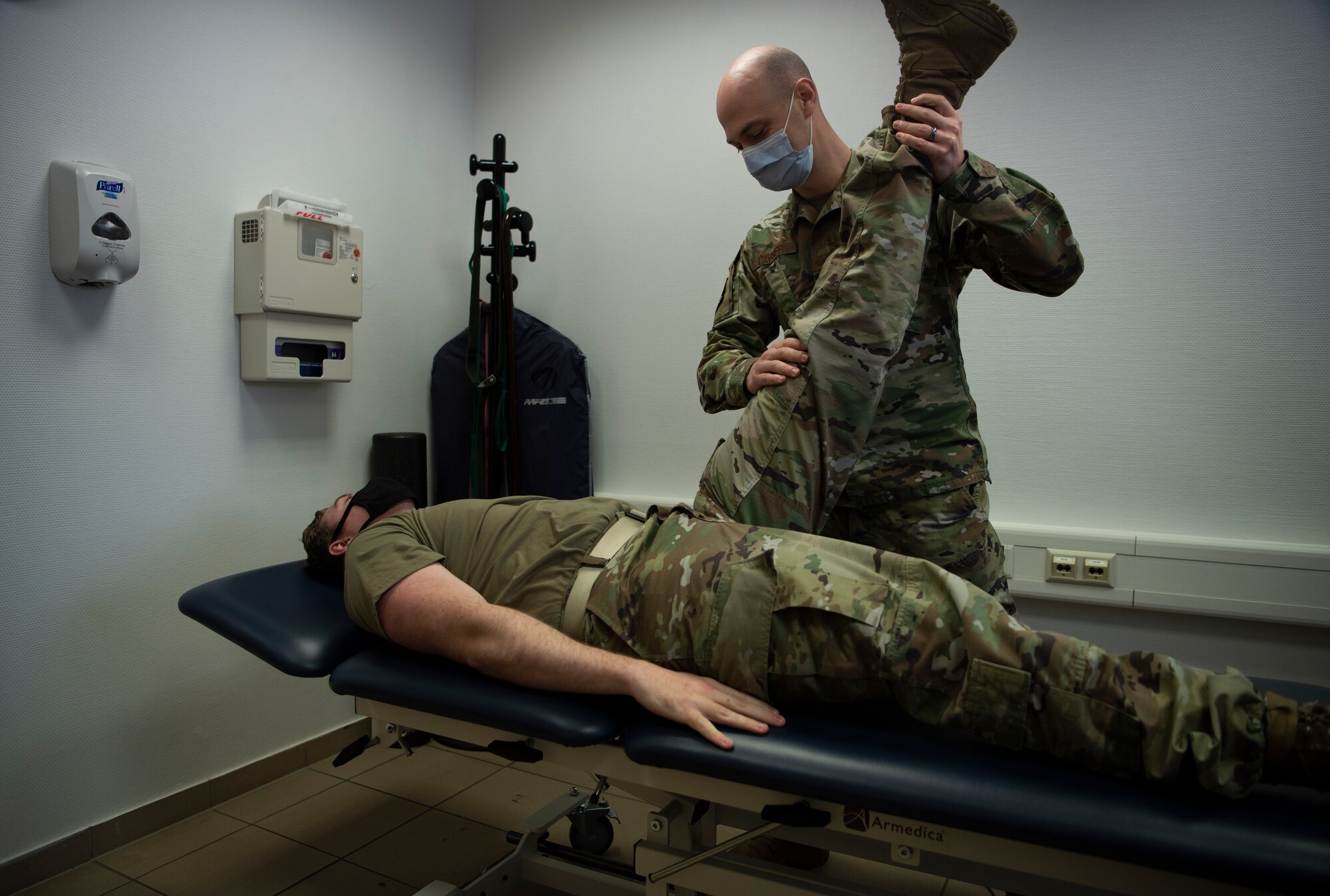 U.S. Air Force 1st Lt. Spencer Carrier, 86th Operational Medical Readiness Squadron physical therapist, performs a stretch on Staff Sgt. Randy Sayer, 86th OMRS physical therapy technician, at Ramstein Air Base, Germany, Jan. 13, 2021.